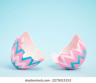 Pink and blue Easter egg open and cracked in half. Empty copy space for text or product. - Shutterstock ID 2275013153
