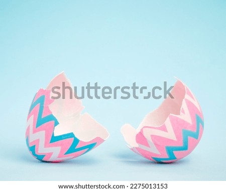 Pink and blue Easter egg open and cracked in half. Empty copy space for text or product.