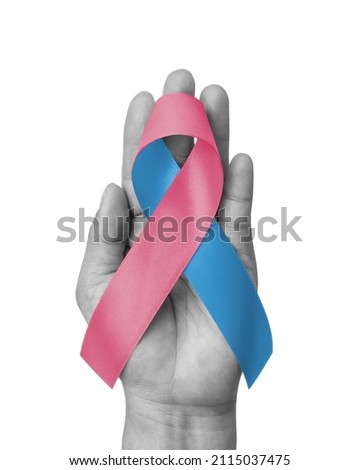 Pink Blue ribbon awareness for Birth defects month, (SIDS) Infertility, Miscarriage, Infant Loss, Amniotic Fluid Embolism, Male breast cancer, bow isolated on white background (clipping path) on hand