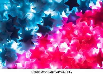 Pink And Blue Stars. Bright Colored Sequins, Tinsel, Confetti. Festive Background For The Gender Party And The Definition Of A Boy Or A Girl. Decor For New Year, Holiday, Birthday. Close Up. Top View.