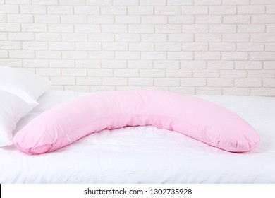 Pink Body Pillow On White Bed