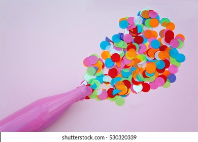 Pink Bottle With Confetti On Pink Background