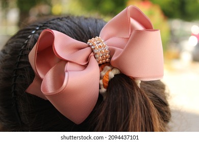 Pink Bow As A Hair Accessory.