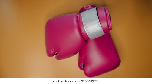  Pink Boxing Gloves With Golden Background And No People. 