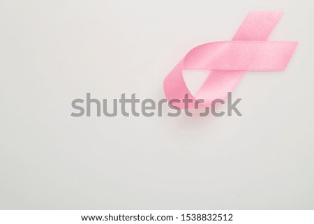 Pink breast cancer ribbon on white background, Concept World breast cancer day, flat lay copy space for text