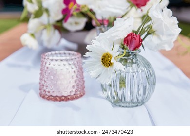 Pink candle and bouquet of flowers. Cozy and inviting atmosphere, summer picnic table setting. - Powered by Shutterstock