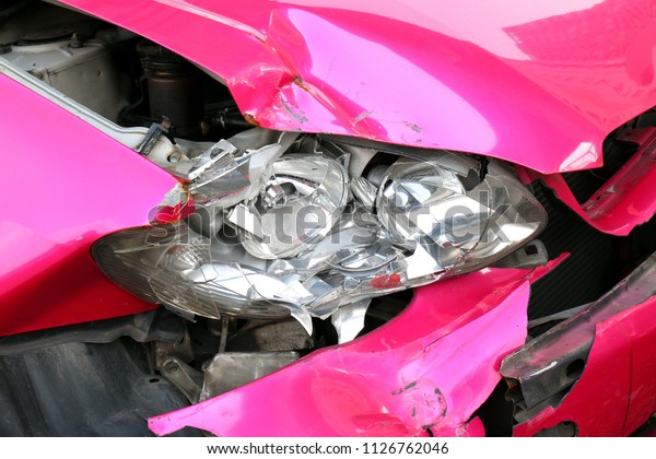 pink car accident damaged to headlights front,\
broken headlights car crash accident, damaged automobiles after\
collision of pink car\
accident