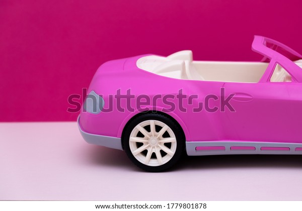 pink car on a pink background.\
Concept of car sale, car rental or car rental. High quality\
photo