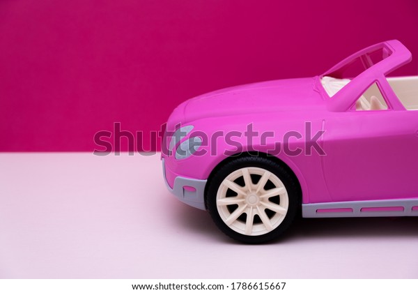pink car on a pink background.\
Concept of car sale, car rental or car rental. High quality\
photo