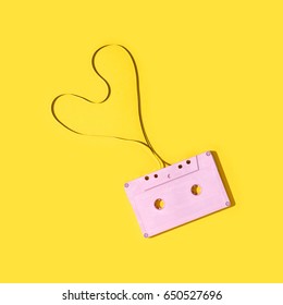 Pink Cassette Tape On A Yellow Background