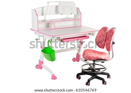 Pink chair, pink school table, green basket and desk lamp on the white isolated background.