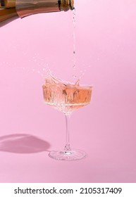 Pink Champagne Pouring In A Glass. Creative Minimal Concept