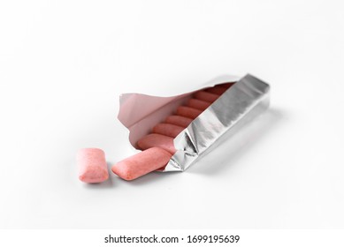 Pink Chewing Gum Drops Out Of The Package. White Background.