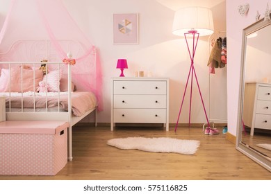 Pink Child Bedroom With Lamp, White Dresser And Bed