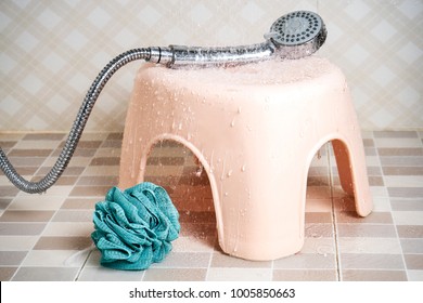 Pink Children Shower Stool Next To Splashes With Splash