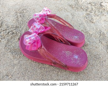 Pink Children's Sandals Filled With Beach Sand