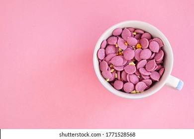 Pink Chocolate Drops In A White Cup On Pink Background. Ruby Chocolate Made From Ruby Cocoa Bean.