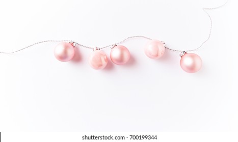 Pink Christmas Balls on a String. Christmas background. White background. Top view. Copy space. 