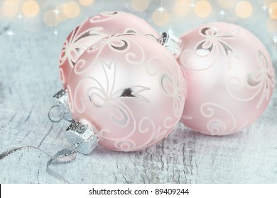 Pink Christmas Ornaments Lying On A Rustic Table. Shallow Depth Of Field.