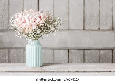 Pink chrysanthemum flower with gypsophila paniculata twigs. Wooden background, copy space. - Powered by Shutterstock