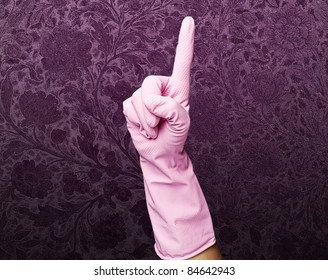 Pink Cleaning Gloves Pointing Up Against A Vintage Wall