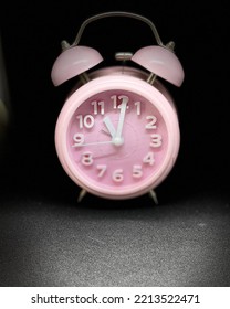 Pink clock in the dark