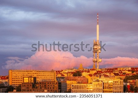 A pink cloud behind the Zizkov TV tower in Prague in sunset.