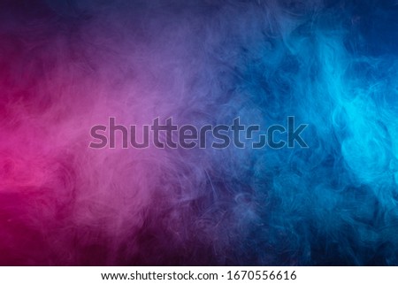 pink cloud of smoke of  black isolated background. Background from the smoke of vape
