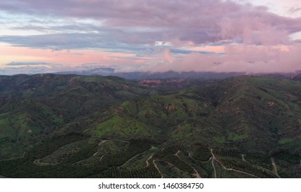 Pink Clouds At Dusk Overlooking An Orange County Backdrop - Santa Ana Mountains Rolling Green Hills Between Storms