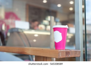 Pink Coffee Cup In Coffee Shop. Copy Space For Logo