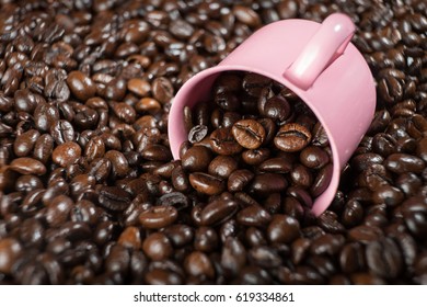 Pink Coffee Mug On Coffee Beans