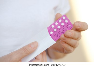 Pink Color Blister In Female Hands. Pack Emergency Contraceptive Pill For Women. Reduces Chance Of Pregnancy. Estrogen And Progestin Oral Contraceptives. 