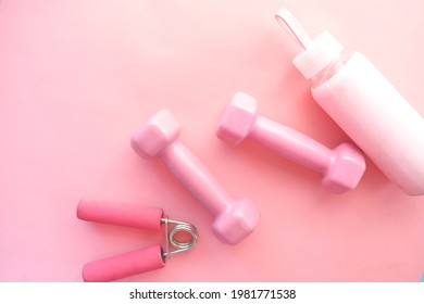  pink color dumbbell, exercise mat and water bottle on white background  - Shutterstock ID 1981771538