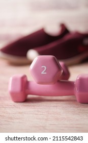  Pink Color Dumbbell, Exercise Mat And Water Bottle On White Background 