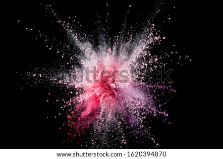 pink color powder exploding on balck background. 