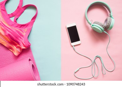 Pink Color Sport Bra And Yoga Mat With Smartphone And Earphones On Pastel Color Background, Healthy Lifestyle Concept