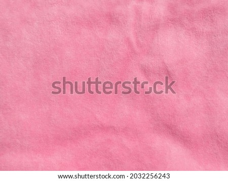 Pink color velvet fabric texture top view. Female blog rose velour tactile background. Smooth soft fluffy velvety satin cloth metallic shiny material.Elegant luxury wallpaper for girls fashion website