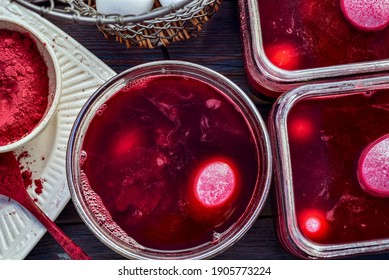 Pink Colored Boiled Eggs In Containers Of Natural Red Dye Bath Made With Beet Root Powder