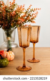 Pink Colored Crystal Champagne Glass, Autumn Flowers On Table