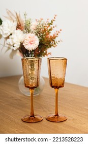 Pink Colored Crystal Champagne Glass, Autumn Flowers On Table