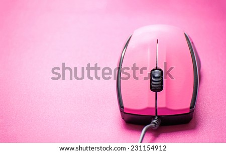 Pink computer mouse on pink background