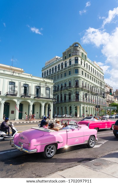 Pink convertible car on a\
tour of old Havana with colonial facades. Havana. Cuba. January 10,\
2020.
