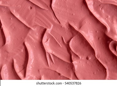 Pink cosmetic clay (facial cream) texture close up, selective focus. Abstract background