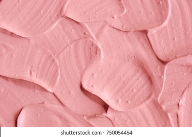 Pink cosmetic clay (facial mask, cream) texture close up, selective focus. Abstract background