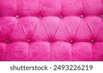 A pink couch with a pink cushion and a pink pillow