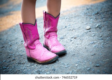 Pink Cowboy boots on gravel