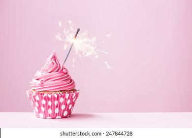 Pink cupcake decorated with a sparkler