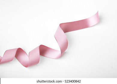 Pink curly ribbon isolated on white - Shutterstock ID 523400842