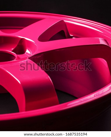 Pink discs lie on an isolated black background.