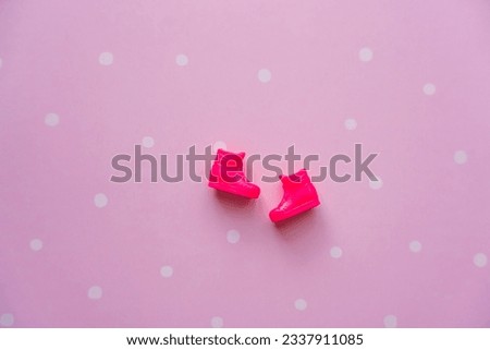 Pink doll boots on a pink background. High quality photo